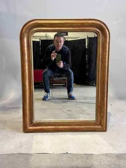 Wood and gilded stucco mantel mirror decorated...