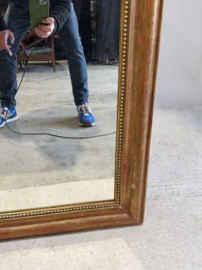 Wood and gilded stucco mantel mirror decorated...