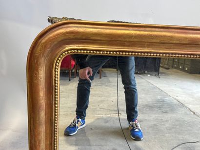 Wood and gilded stucco mantel mirror decorated...