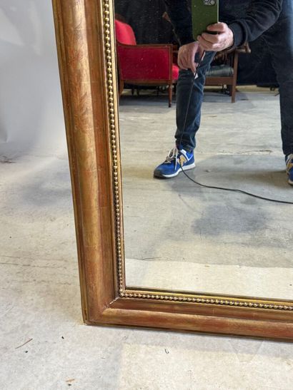 Wood and gilded stucco mantel mirror decorated...