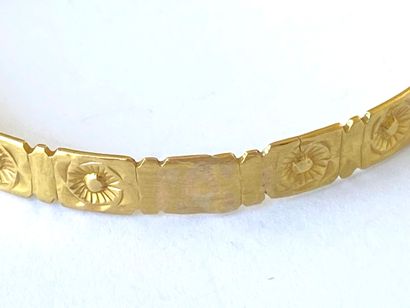 Yellow gold bangle decorated with stylized...