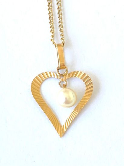 Yellow gold neck chain adorned with an openwork...