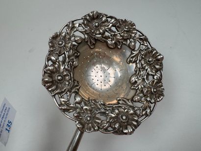 Large foreign silver tea strainer with repoussé...