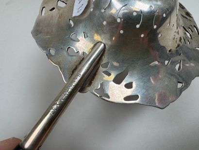 Large foreign silver tea strainer with repoussé...