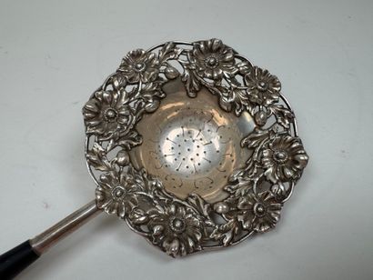 Large foreign silver tea strainer with repoussé...