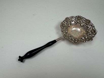 Large foreign silver tea strainer with repoussé...