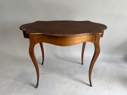A scalloped-edge table made of stained wood...