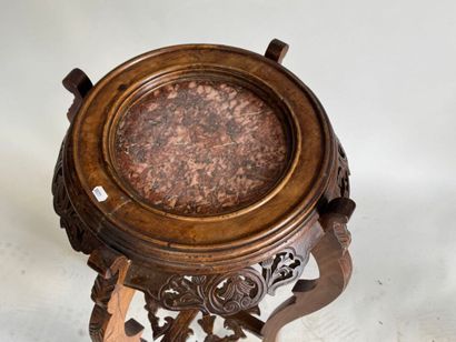 A four-legged pedestal table made of molded,...