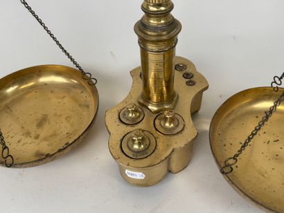 A chiseled bronze apothecary's balance scale...