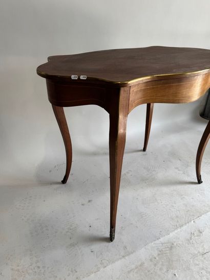 A scalloped-edge table made of stained wood...
