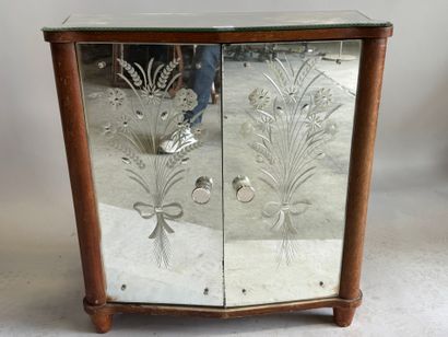 Small two-door cabinet made of wood with...