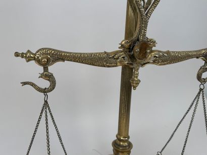 A chiseled bronze apothecary's balance scale...