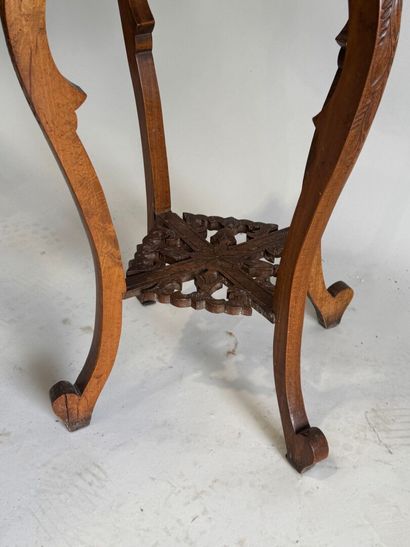 A four-legged pedestal table made of molded,...
