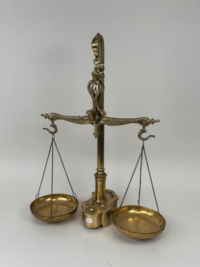 A chiseled bronze apothecary's balance scale...