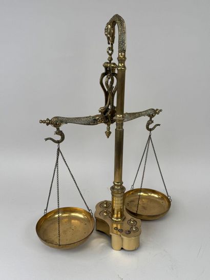 A chiseled bronze apothecary's balance scale...