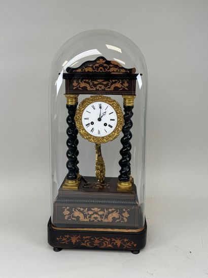 A portico clock in blackened wood with light...