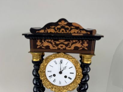 A portico clock in blackened wood with light...