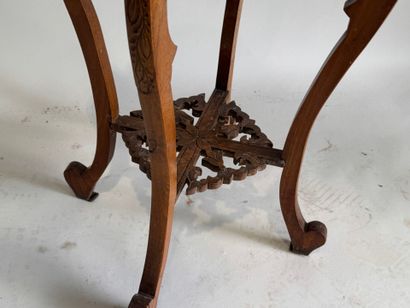 A four-legged pedestal table made of molded,...