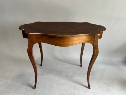 A scalloped-edge table made of stained wood...