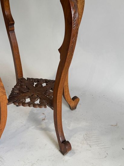 A four-legged pedestal table made of molded,...