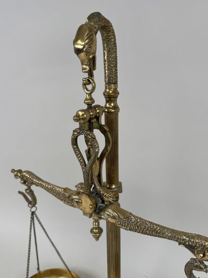 A chiseled bronze apothecary's balance scale...