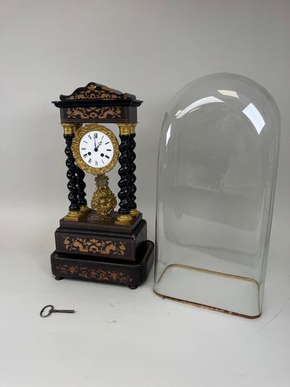 A portico clock in blackened wood with light...