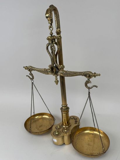 A chiseled bronze apothecary's balance scale...