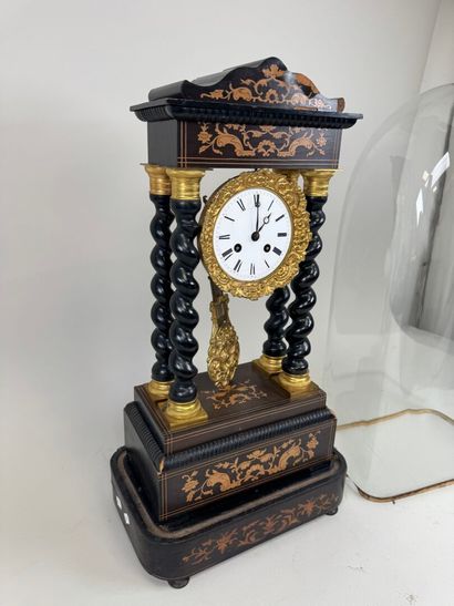 A portico clock in blackened wood with light...