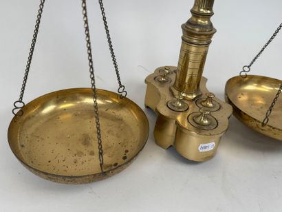 A chiseled bronze apothecary's balance scale...
