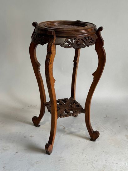 A four-legged pedestal table made of molded,...