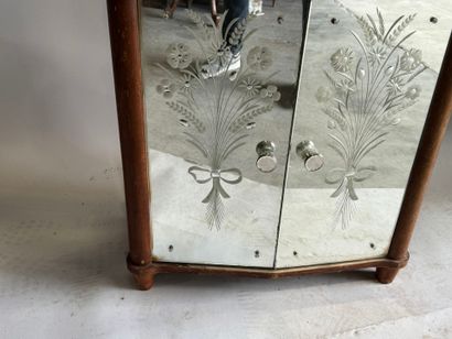 Small two-door cabinet made of wood with...