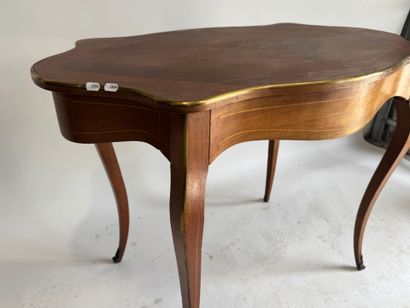 A scalloped-edge table made of stained wood...