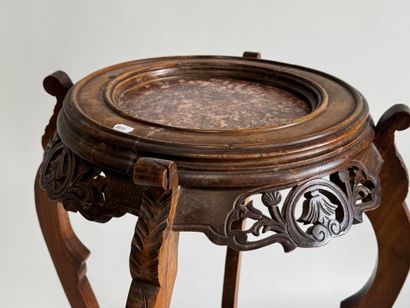 A four-legged pedestal table made of molded,...