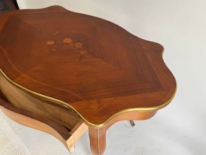 A scalloped-edge table made of stained wood...