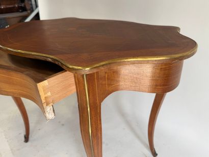 A scalloped-edge table made of stained wood...