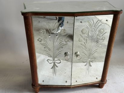 Small two-door cabinet made of wood with...