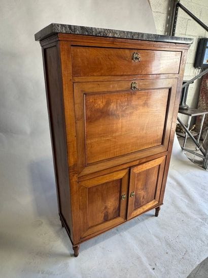 Walnut drop-leaf desk with a veined gray...