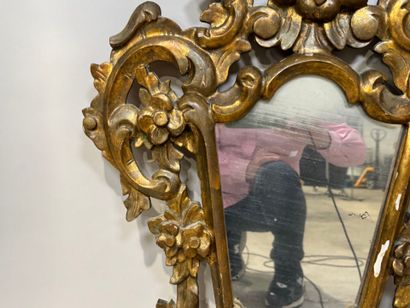 Gilded and openworked wood and stucco mirror...