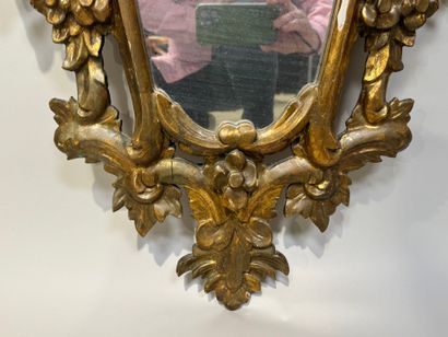 Gilded and openworked wood and stucco mirror...
