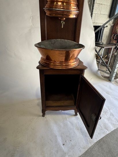 Copper fountain on a molded oak display cabinet....
