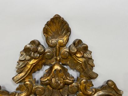 Gilded and openworked wood and stucco mirror...