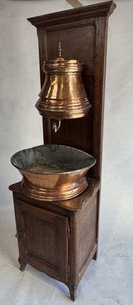 Copper fountain on a molded oak display cabinet....