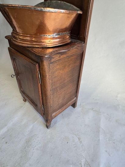 Copper fountain on a molded oak display cabinet....