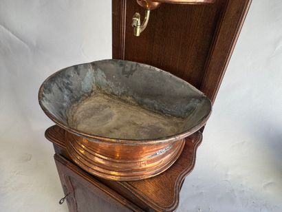 Copper fountain on a molded oak display cabinet....