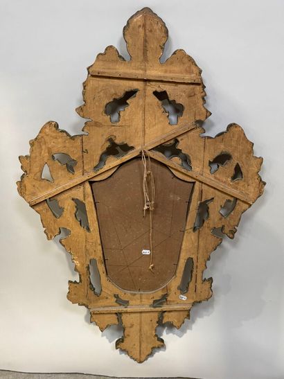 Gilded and openworked wood and stucco mirror...