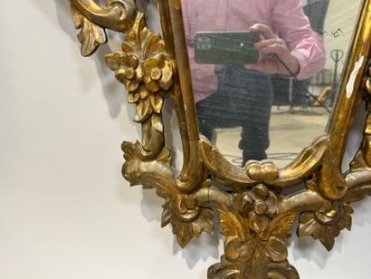 Gilded and openworked wood and stucco mirror...