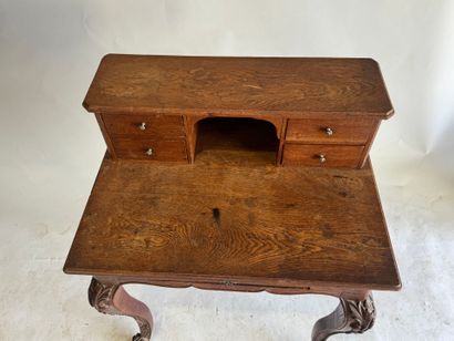 Stepped oak desk with four drawers and a...