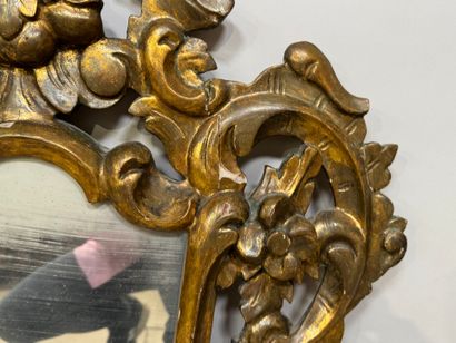 Gilded and openworked wood and stucco mirror...