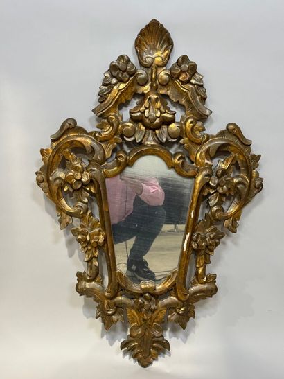 Gilded and openworked wood and stucco mirror...