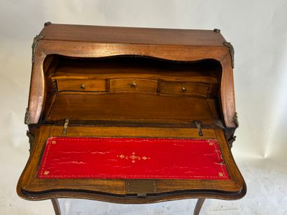 A slanted desk that opens via a leather-covered...
